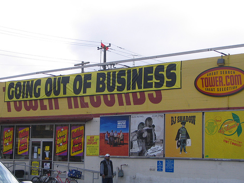 A storefront with a long “going out of business” banner.