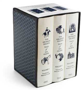 A box set of THE ARABIAN NIGHTS in 3 volumes, which are white with blue print and line artwork.