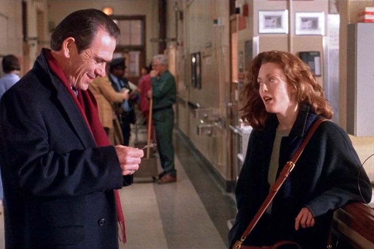 A still shot from the movie THE FUGITIVE. Here, Tommy Lee Jones's character (a federal marshal) is interacting with Julianne Moore's character (a nurse).