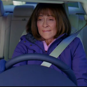 A still shot of actress Patricia Heaton of the TV show THE MIDDLE buckled in the driver's seat of a car looking distressed and about to blow.